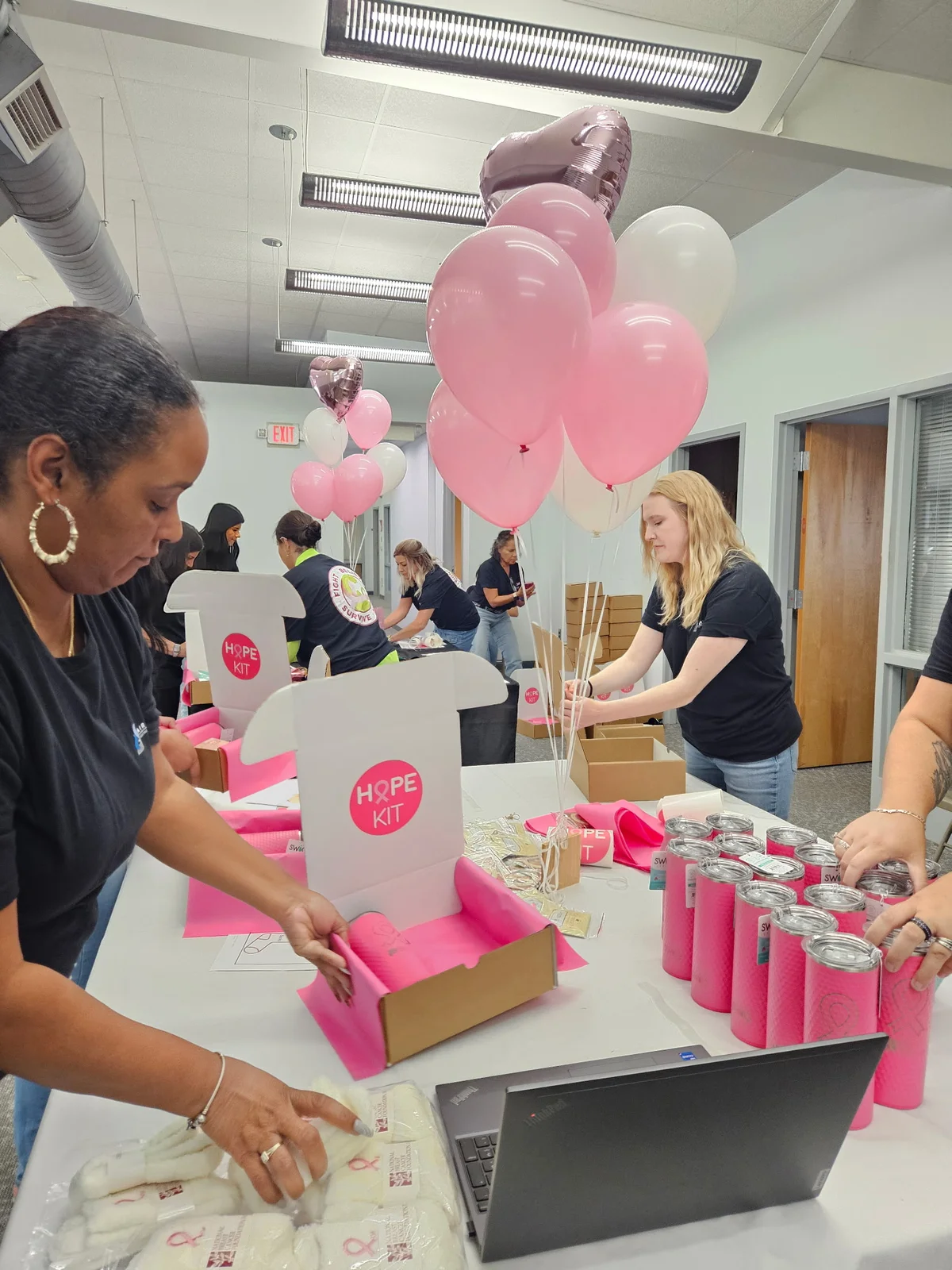 Air Experts team members packing Hope Kit boxes with comfort items