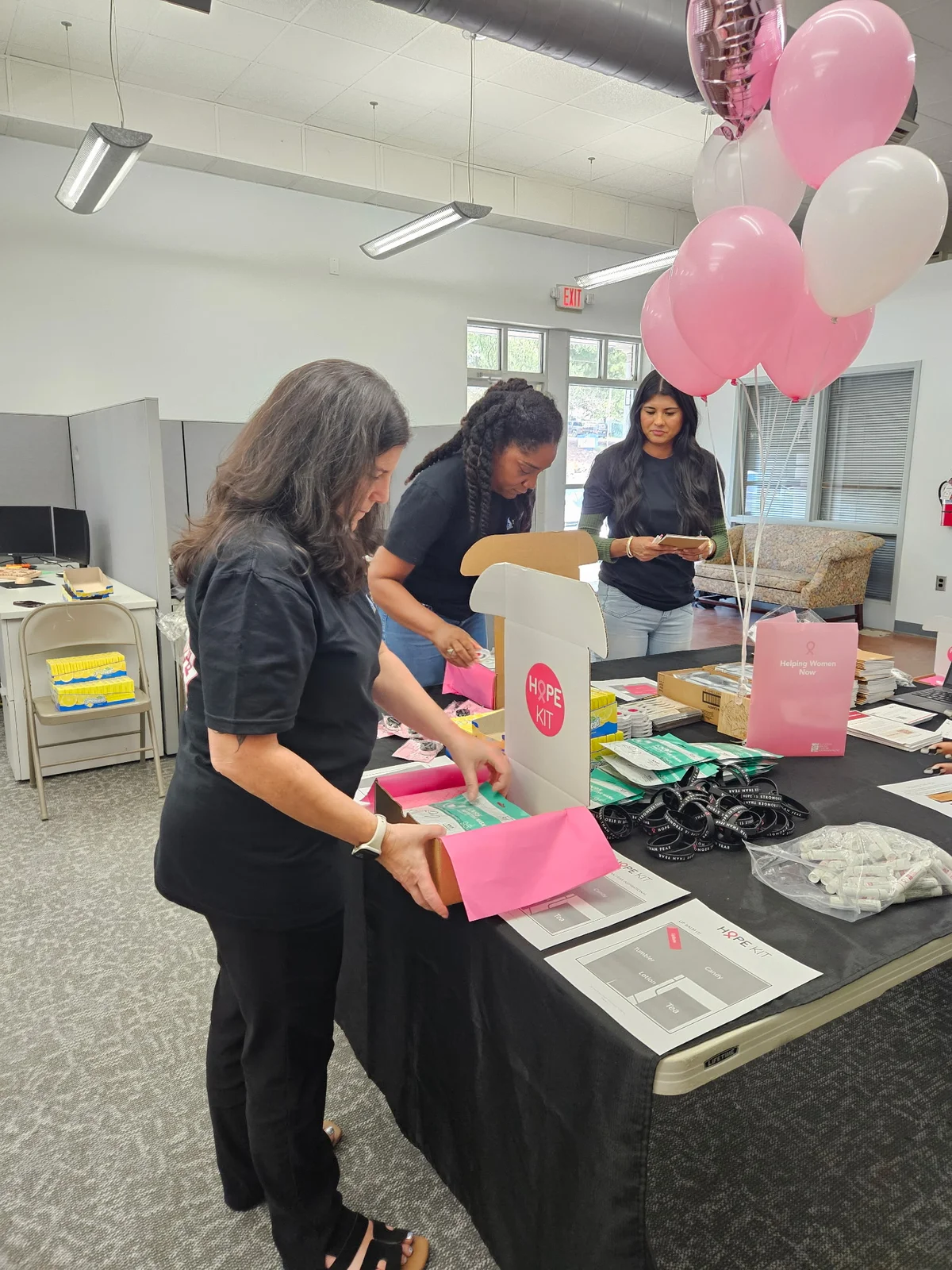 Air Experts team members gathered around a table of Hope Kit supplies