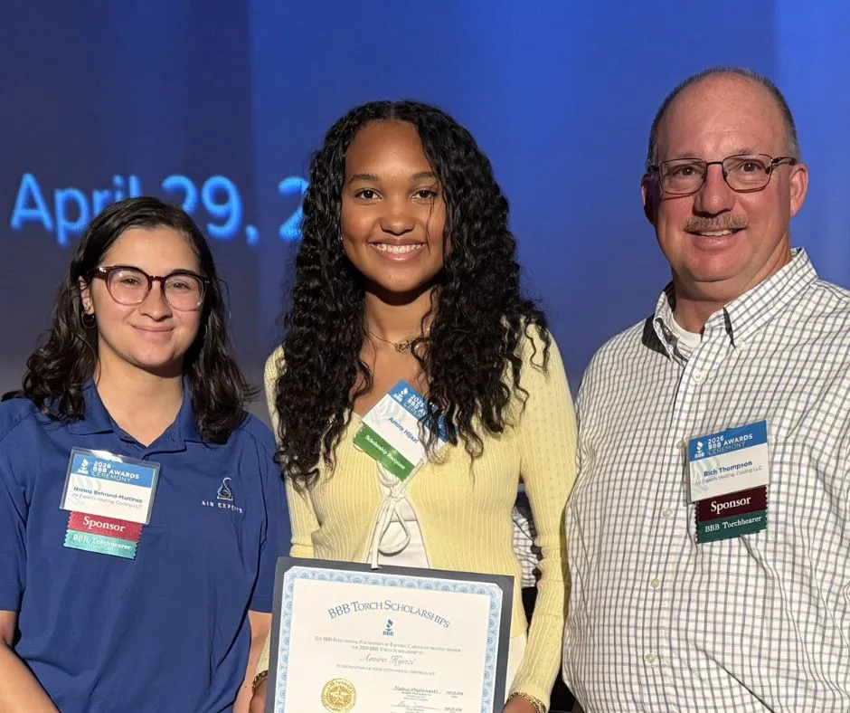 Air Experts team members with a BBB Torch Scholarship recipient holding her scholarship certificate at the BBB Awards Ceremony